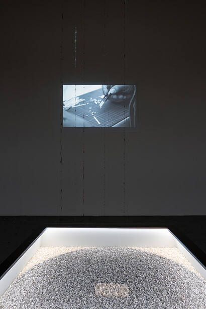 Sabrina Mezzaqui - Il tavolo di Plotino 2017-2024, a table containing thousands of paper scraps: the Greek words of the Enneads (Plotino, Enneadi, Bompiani), cut out in various collective work meetings in San Gimignano and Maccastorna