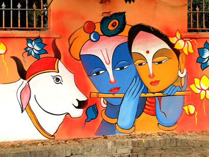 Painting on the roadside wall depicting Lord Krishna playing flute
