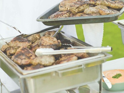 Gas grill barbequing meat