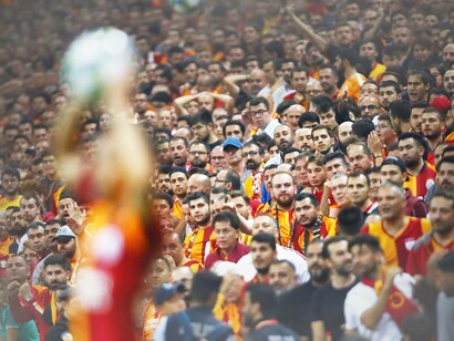 The Galatasaray fans watching eagerly their team take a throw-in from an attacking position