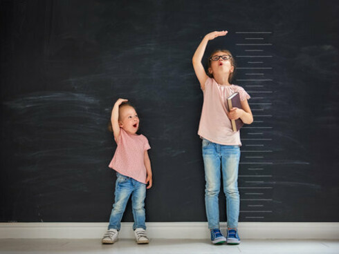 Bambine che si misurano l'altezza