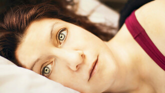 A woman unable to sleep, poor sleep quality has been linked to several medical conditions 