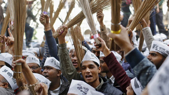 AAP followers waving brooms