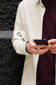 Person using a phone with a search bar visible, showcasing AI-driven search results and Google’s latest search engine advancements