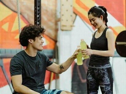 A woman taking a break mid-workout with her companion, reflecting how small wins build lasting confidence