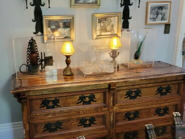 Historic furnishings and family photographs inside the Ernest Hemingway Home & Museum in Key West, Florida, representing the history of the Hemingway family on the island