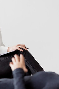 Capture a compelling front view of a psychologist guiding a patient through Exposure and Response Prevention (ERP) therapy, addressing Obsessive-Compulsive Disorder (OCD) and anxiety disorders with expertise and compassion