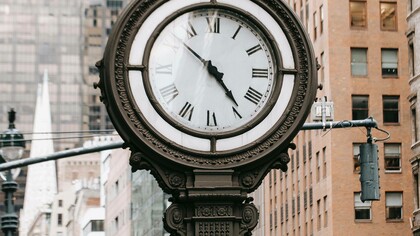 A clock in a busy city