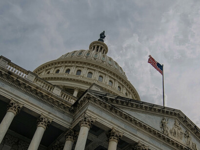 The U.S. Capitol, a landmark in Washington, D.C., pictured with the American flag