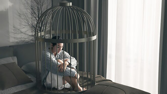 A woman practicing self-restraint lies in a bed cage, demonstrating control in a confined space