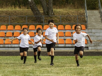 Young teammates engaged in friendly competition, reflecting the growth that comes through participation