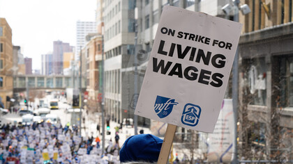 Educators from Minneapolis schools march through downtown Minneapolis, USA