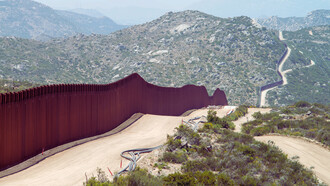 The USA–Mexico border wall in Southern California, cutting through the mountains