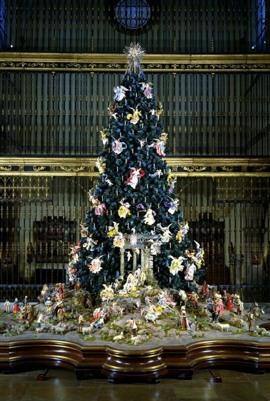 Annual Christmas Tree and Neapolitan Baroque Creche display 20 ft. blue spruce with a collection of 18th-century Neapolitan angels and cherubs among its boughs and groups of realistic crèche figures flanking the Nativity scene at its base, displayed in the Museum's Medieval Sculpture Hall Gift of Loretta Hines Howard, 1964. Behind the tree: Reja from the Cathedral of Valladolid, Spanish, 1763, Wrought iron, partially gilt, and limestone 52 x 42 ft. (15.86 x 12.81 m). Gift of The William Randolph Hearst Foundation, 1956. Courtesy of The Metropolitan Museum of Art.