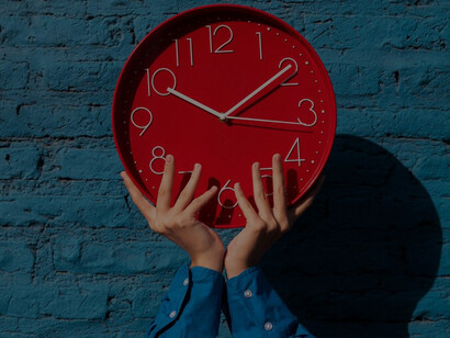 A woman gracefully holding a wall clock, framed by captivating complexity diagrams and the timeless allure of clock faces, evoking contemplation on the intricate interplay of timepieces and temporal complexities