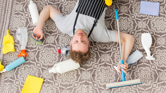 A tired man from cleaning the carpet, seen from above