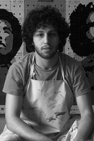 Youness Miloudi sitting in front of one his artistic pieces photo by Abdelhak Sabri
