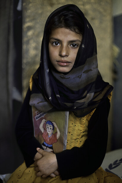 Menina de Kabul com seu caderno. Fotografia Steve McCurry  