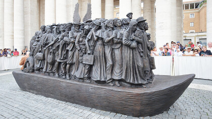 “Angels Unaware” sculpture, depicts 140 migrants and refugees from various historical periods traveling on a boat, and includes indigenous people, the Virgin Mary and Joseph, Jews fleeing from Nazi Germany, and those from war-torn countries. Displayed in St. Peters Square