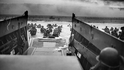 "Into the jaws of death", June 6, 1944 (Robert F. Sargent). Taken during the D-Day landings of World War II, U.S. Army soldiers of the 1st Infantry Division wade through the surf toward Omaha Beach in Normandy