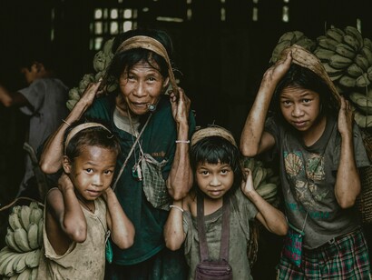 A family bringing the bananas they have collected from the mountains in in Sitio Linyama, Philippines