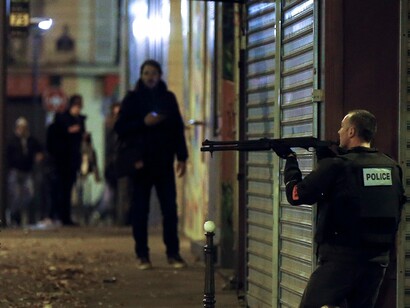 A French police officer gives cover to his colleagues as they search for the gunman who attacked the restaurant Le Petit Cambodge. Photograph: Etienne Laurent/EPA