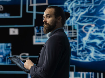 Focused young entrepreneur building a deep learning AI brain model in a modern workspace