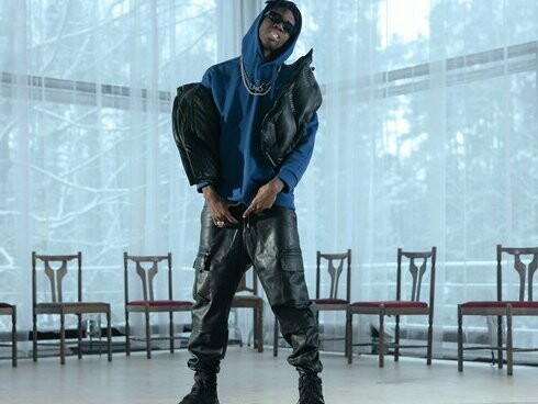 A performer rapping in a vacant studio, representing how creators remix global trends into their own voice