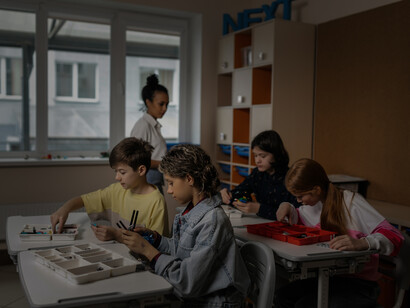 Children learning in a classroom with their teacher. Teaching is an act of guidance, leading rather than correctness and discipline