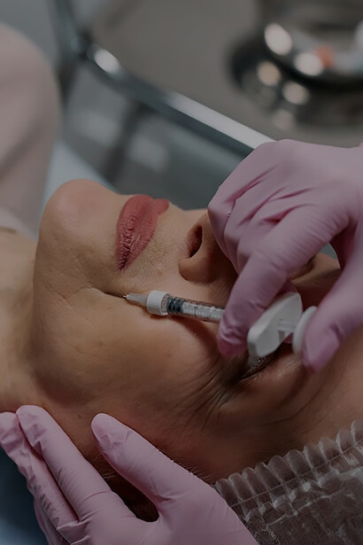 Graceful aging: a senior woman receives expert filler application from a doctor in pink gloves for a radiant facial enhancement