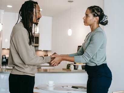 Two people standing together showing empathy for each other 