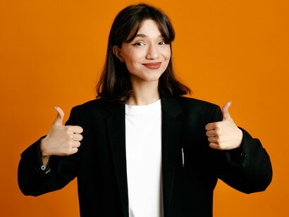 An overly reassuring gesture delivered with a practiced smile, symbolizing approval used as a shield against conflict