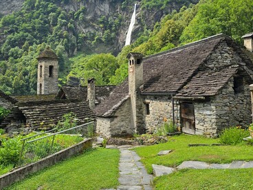 Rustic stone homes with layered slate roofs, reflecting how regional materials and environmental context can influence architectural identity