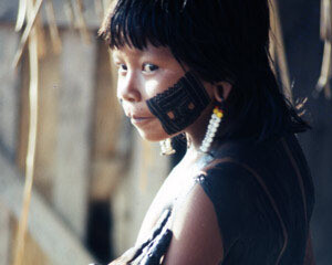 A young girl being painted with a men ôk kumrent design with genipa americana and charcoal. Photo: Darrell Posey, circa 1986. © Pitt Rivers Museum, University of Oxford (2001.82.233).