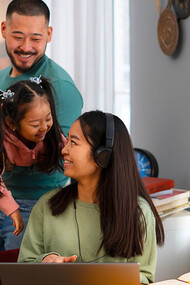 A mother taking a mindful break from work to watch her her family and engage with them, representing the importance of being present in small moments