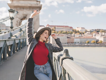 Pretty female tourist in casual outfit having fun in city 