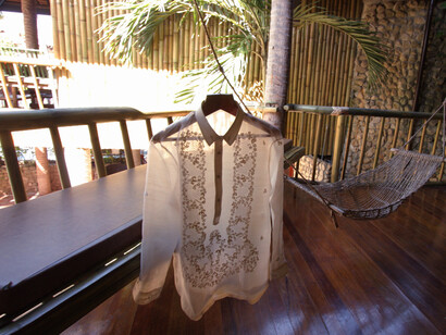 A symbol of Filipino heritage and elegance, the Barong Tagalog hangs gracefully, showcasing its delicate embroidery and fine craftsmanship