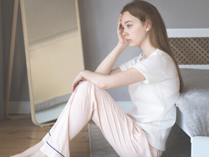 An anxious woman sitting on floor