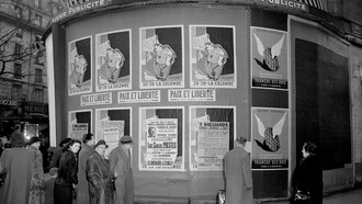 Political posters in Paris, such as the "Jojo la Colombe" caricature of Stalin, represent the intense battle against communism during a turbulent period in history