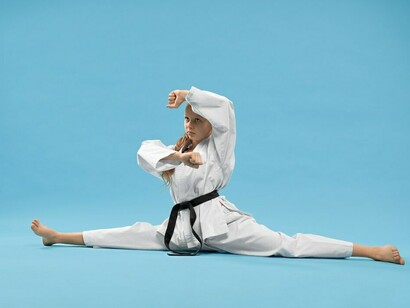 A student-athlete balancing sports and academics, surrounded by textbooks, demonstrates the importance of time management and focus required for success in both areas, especially when pursuing a sports scholarship