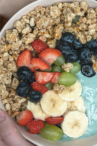 A fruit bowl with spirulina powder, a nutrient-rich supplement made from blue-green algae