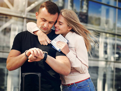 A joyful couple reunited at the airport, sharing a kiss after relocating abroad for love