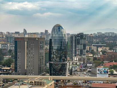 Glass-covered skyscrapers standing above Nairobi’s busy city roads, symbolizing Kenya’s modern infrastructure and business growth