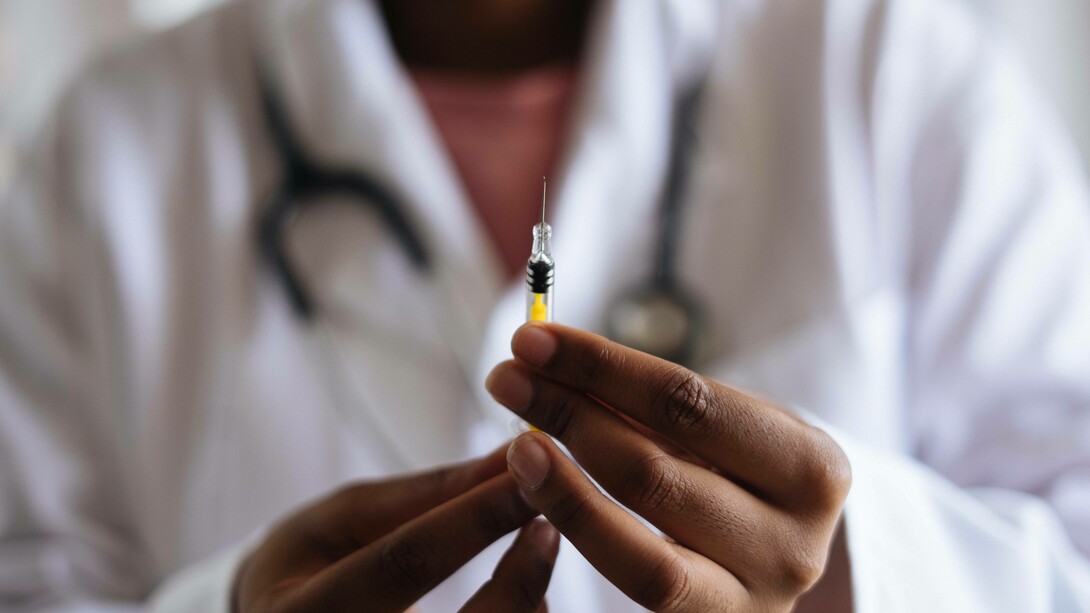 Doctor measuring a dose of vaccine