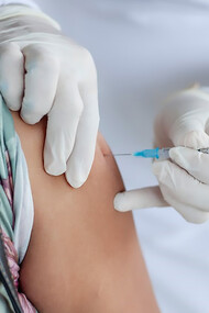 In Sucre, Colombia, a dedicated doctor administers a crucial vaccination to a patient in the rural village of Ovejas, exemplifying the importance of healthcare outreach in underserved communities