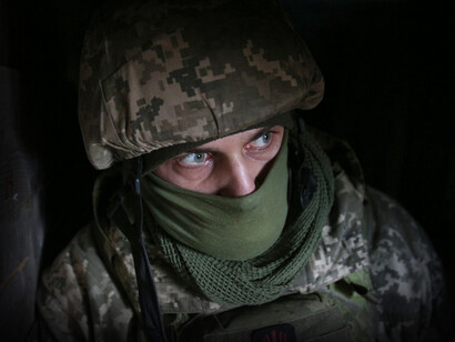 Soldado ucraniano mira fijamente hacia el exterior de su trinchera