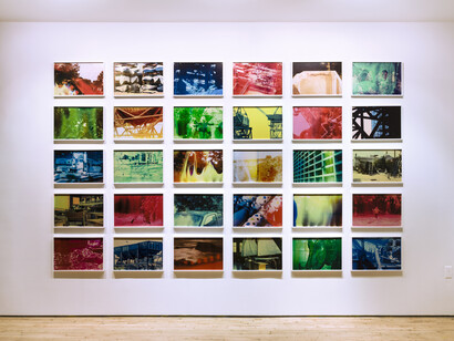 Basim Magdy, The Hollow Desire to Populate Imaginary Cities, 2014. 30 C-Prints from chemically altered slides on metallic paper 34 x 51 cm each. Installation view at Art in General. Image courtesy the artist and Art in General. Photo: Charles Benton.