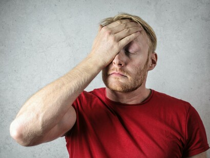 A man standing, showing signs of anxiety