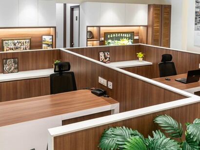 An unoccupied office workstation with computers and neatly arranged desks, representing workforce reduction and the changing role of human labour