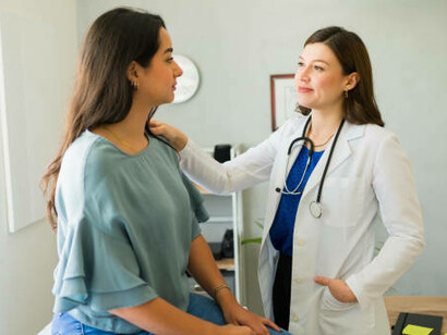 Portrait of a doctor operating a mammography X-ray scanner in a hospital setting
